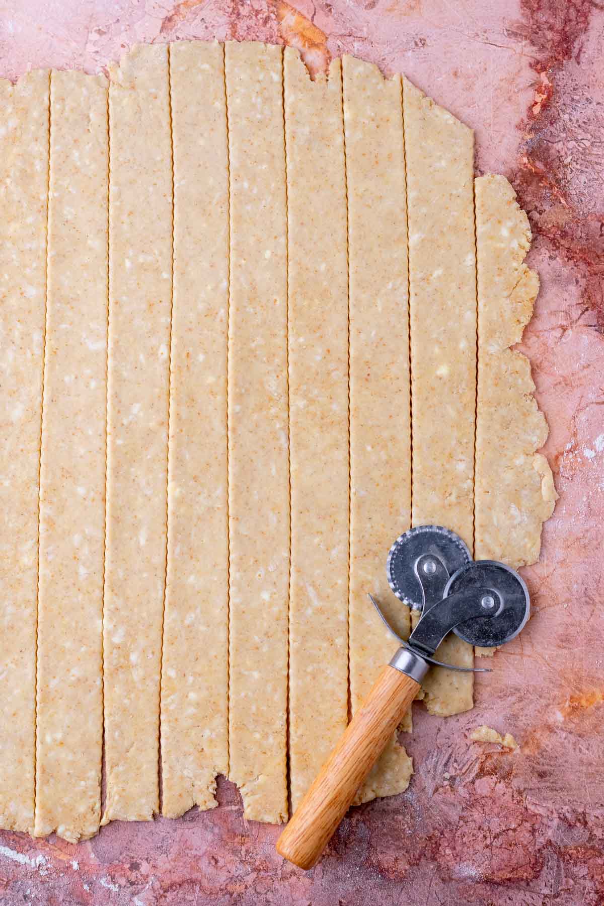 Sourdough graham cracker pie crust cut with a pastry wheel into lattice strips.