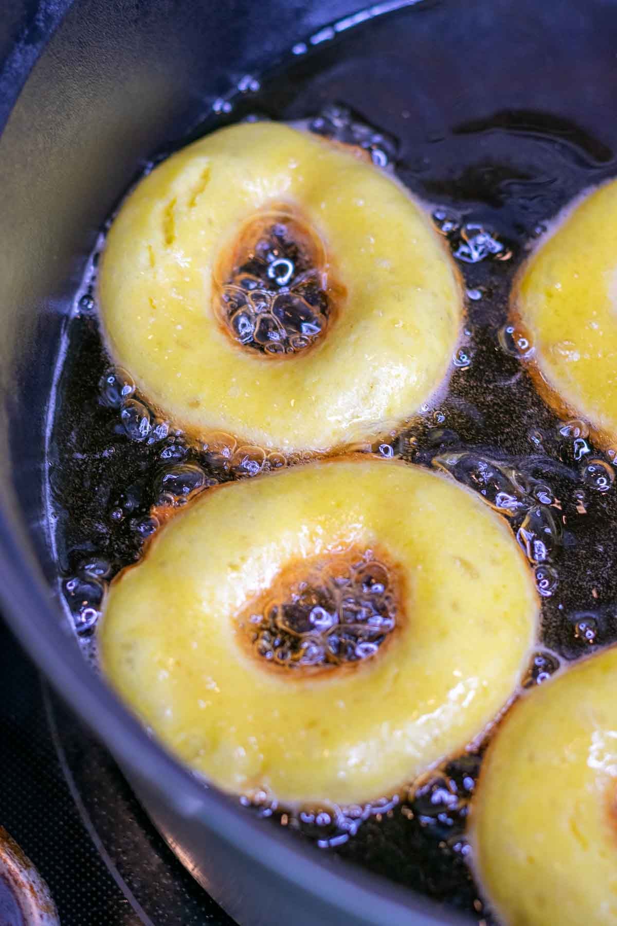 Frying sourdough crullers in a large dutch oven.