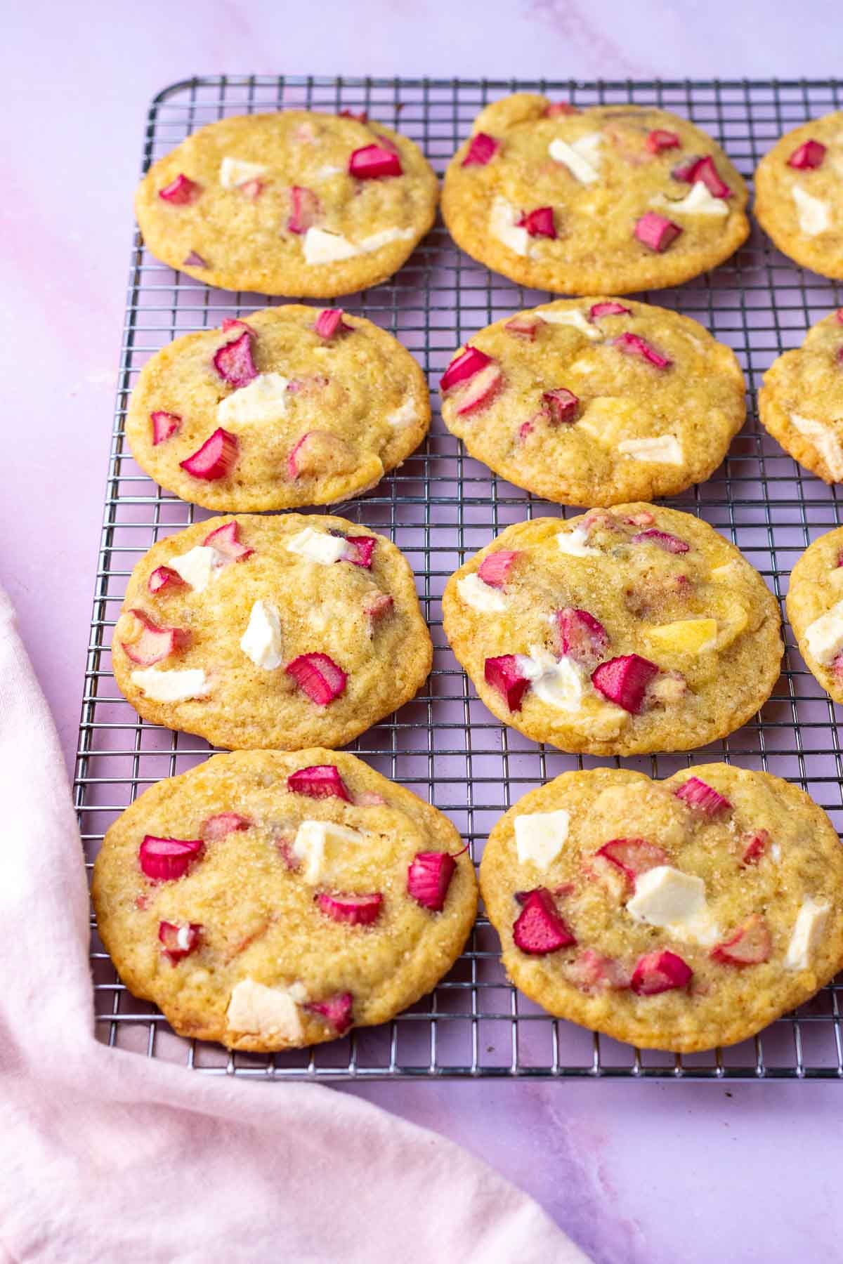 Wire cooling rack with sourdough rhubarb cookies and white chocolate.