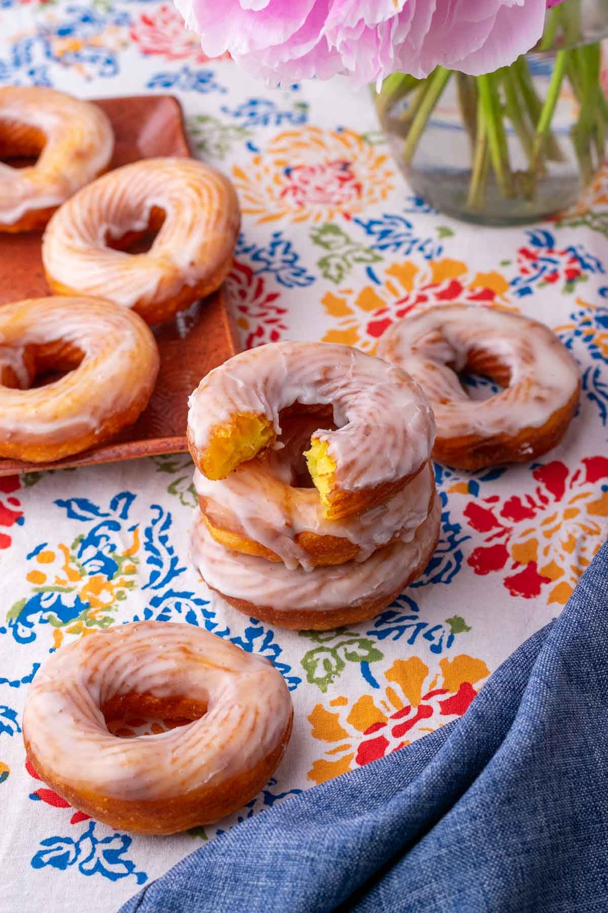Stack of sourdough crullers with a bite taken out of the top one.
