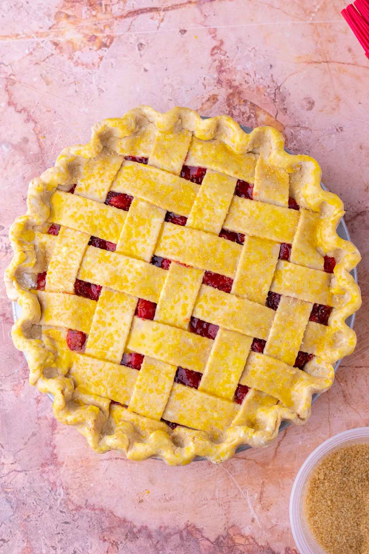 Unbaked sourdough strawberry rhubarb pie with a lattice sourdough graham cracker crust.
