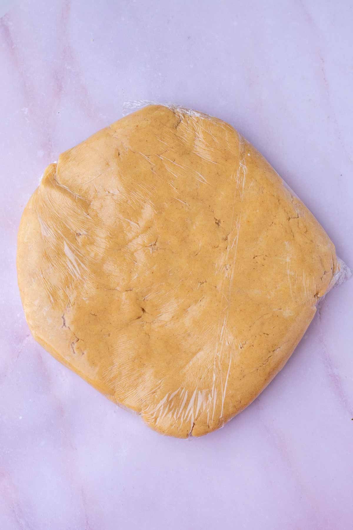 sourdough animal cracker dough in plastic wrap.