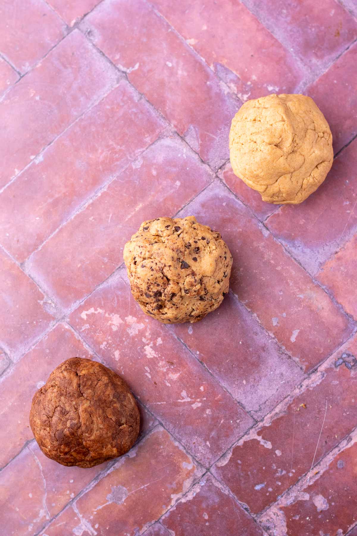 Three different flavors of sourdough teddy graham doughs including chocolate, chocolate chip, and cinnamon.