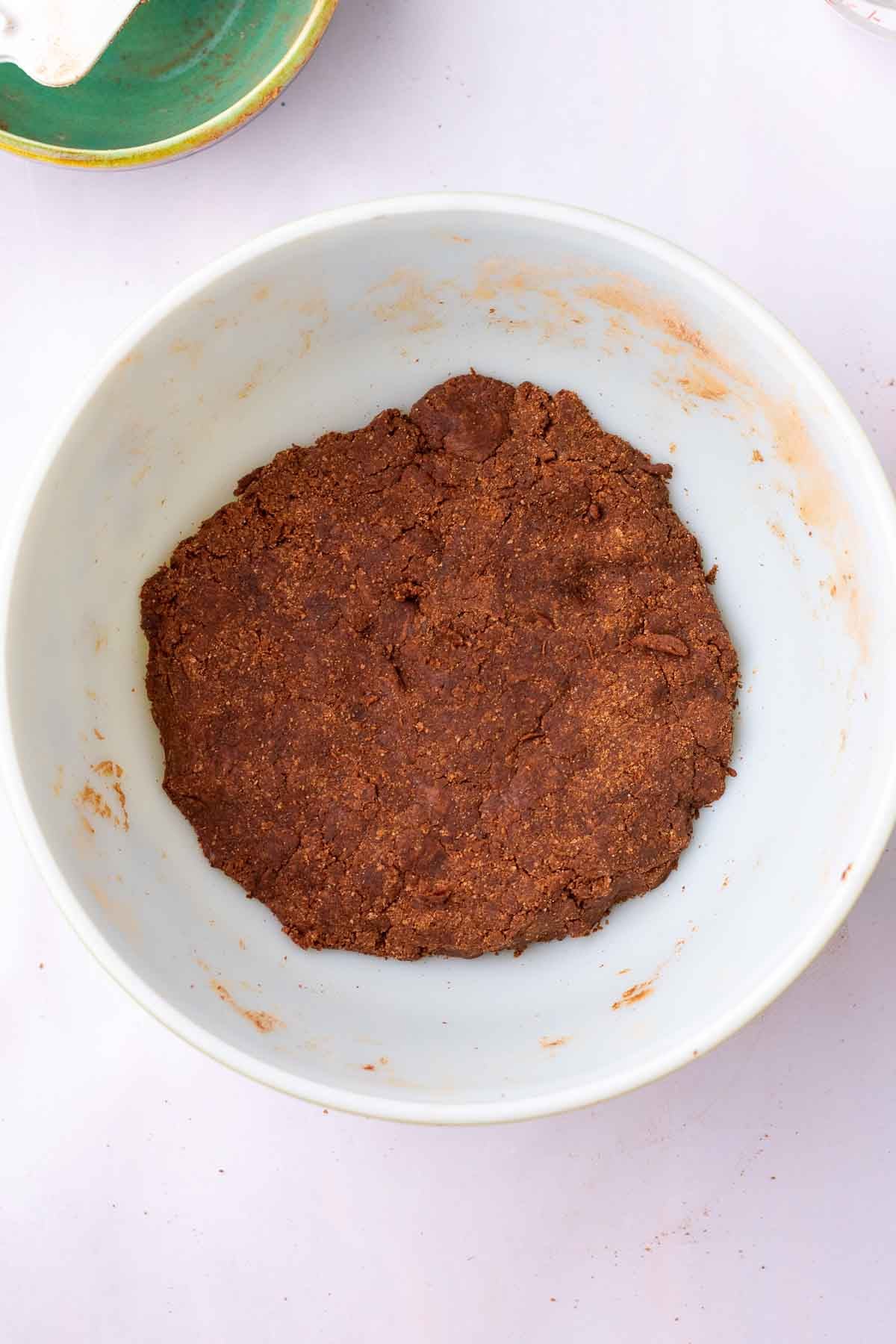 Mixed sourdough cocoa puffs dough in a bowl.