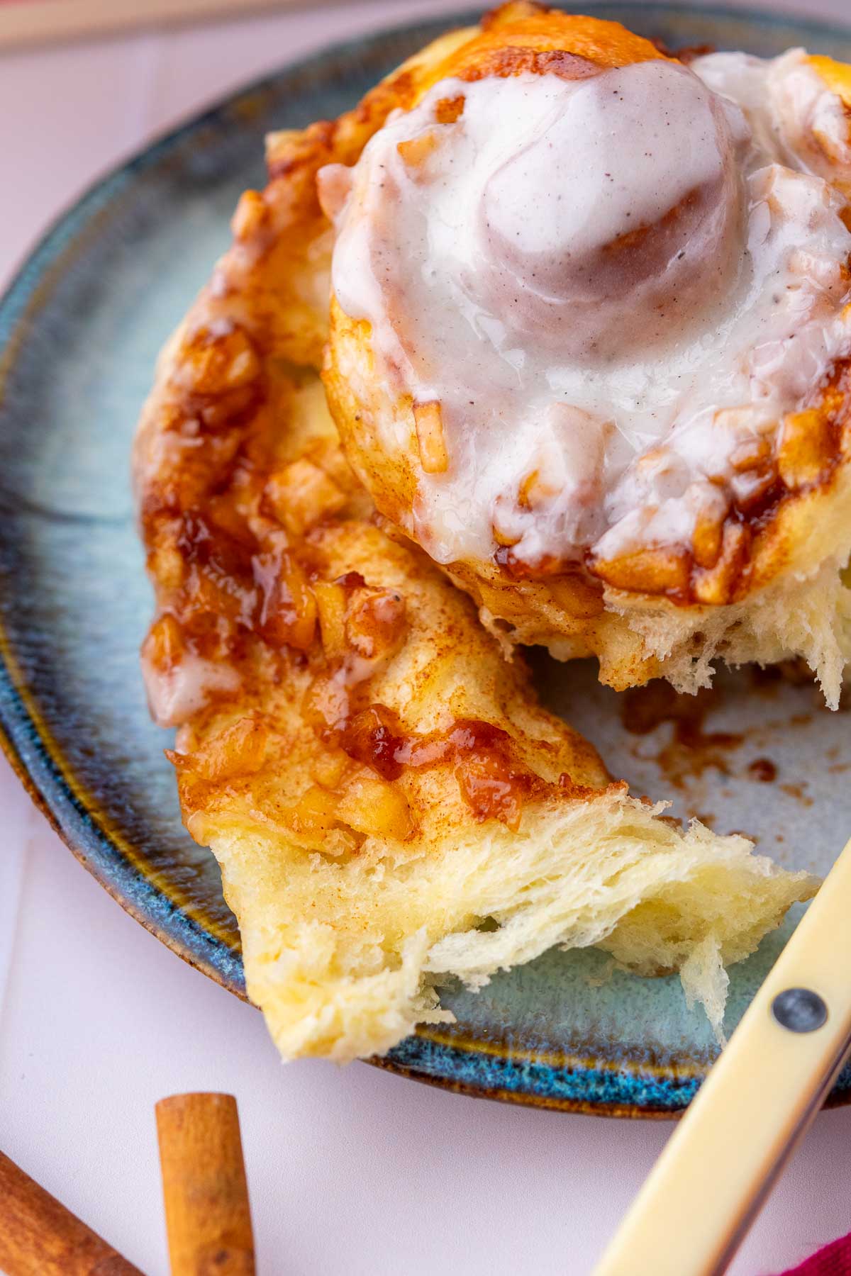 Close up of a sourdough apple cinnamon roll being pulled apart.