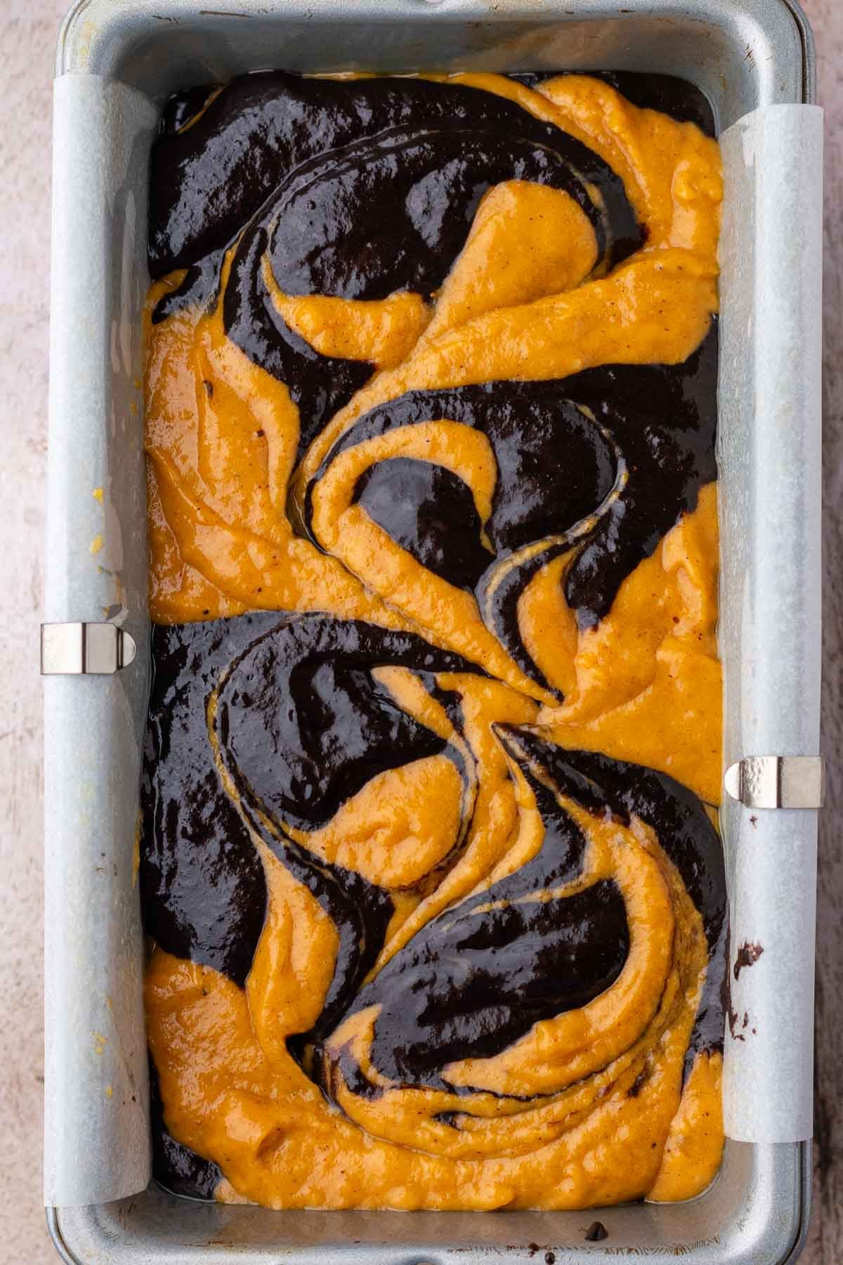 Marbled sourdough pumpkin marble bread unbaked in loaf pan